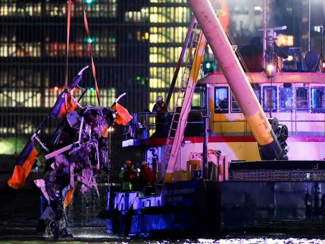 Emergency personnel work at the scene of a helicopter crash on the Hudson River near lower Manhattan in New York, as seen from Newport, New Jersey, on April 10, 2025. Eduardo Munoz/Reuters