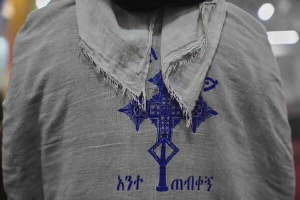 A congregant wears a netela, a white scarf-like cotton cloth, during a service at Re'ese Adbarat Debre Selam Kidist Mariam Church, an Ethiopian Orthodox Tewahedo church, in Washington, D.C., Saturday, April 5, 2025. (AP Photo/Jessie Wardarski)