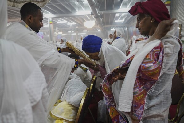 A congregant bows to kiss the holy Gospel during a service at Re'ese Adbarat Debre Selam Kidist Mariam Church, an Ethiopian Orthodox Tewahedo church, in Washington, D.C., Saturday, April 5, 2025. (AP Photo/Jessie Wardarski)