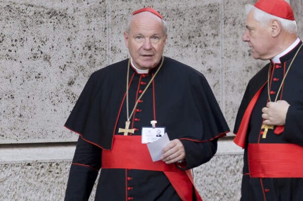 Austrian Cardinal Christoph Schoenborn, left, and German Cardinal Gerhard Ludwig Mueller arrive for the morning session of the synod on the family, a two-week meeting of 200 cardinals and bishops from around the world, at the Vatican on Oct. 9, 2014. (AP Photo/Alessandra Tarantino, File)