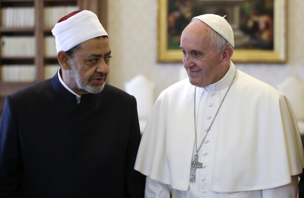 FILE - In this Monday, May 23, 2016 file photo, Sheikh Ahmed el-Tayeb, Grand Imam of Al-Azhar Mosque, talks with Pope Francis during a private audience in the Apostolic Palace, at the Vatican. Pope Francis is facing a religious and diplomatic balancing act as he heads to Egypt this weekend, hoping to comfort its tiny Christian community after a spate of Islamic attacks while seeking to improve relations with Egypt's Muslim leaders. (Max Rossi/Pool photo via AP)