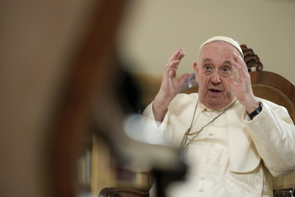 Pope Francis speaks during a news conference aboard the papal flight on its way back from Brazil, Monday, July 29, 2013. Pope Francis reached out to gays on Monday, saying he wouldn't judge priests for their sexual orientation in a remarkably open and wide-ranging news conference as he returned from his first foreign trip.