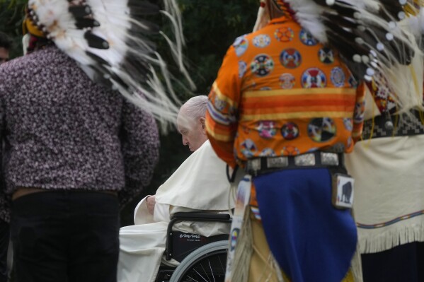 Pope Francis prays with Indigenous peoples in a cemetery at the former residential school, in Maskwacis, near Edmonton, Canada, Monday, July 25, 2022. Pope Francis begins a