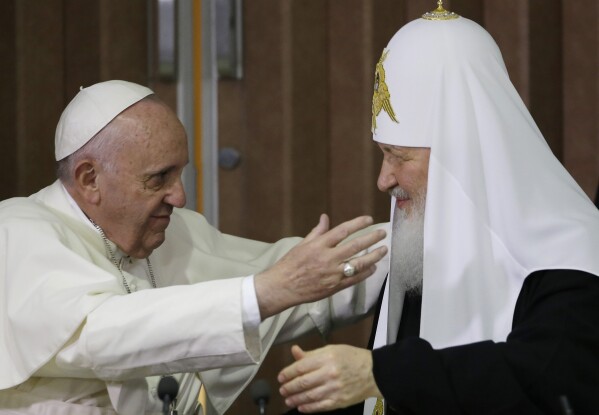 Pope Francis, left, reaches to embrace Russian Orthodox Patriarch Kirill after signing a joint declaration at the Jose Marti International airport in Havana, Cuba, Friday, Feb. 12, 2016. The two religious leaders met for the first-ever papal meeting, a historic development in the 1,000-year schism within Christianity. (AP Photo/Gregorio Borgia, Pool)