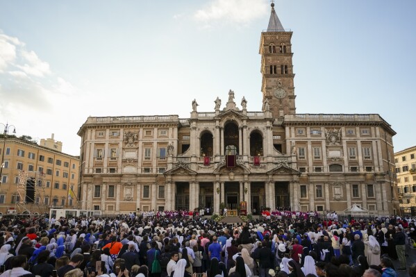 Faithful gather in front of St. Mary Major Basilica where Pope Francis presided over a procession on the Catholic festivity of Corpus Domini (Body of the Lord), in Rome, Sunday, June 2, 2024. (AP Photo/Alessandra Tarantino, file)