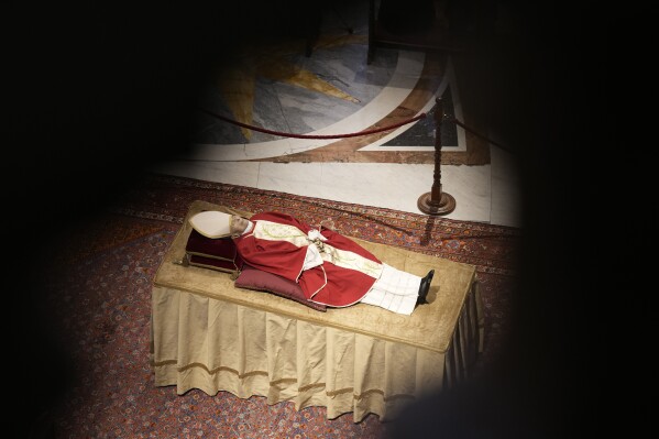 The body of late Pope Emeritus Benedict XVI lies out in state inside St. Peter's Basilica at The Vatican, Tuesday, Jan. 3, 2023. (AP Photo/Andrew Medichini, file)