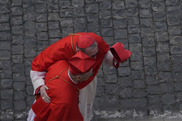 Prelates walk at St. Peter's Square ahead of the arrival of the body of Pope Francis, who will lie in state at St. Peter's Basilica for three days, at the Vatican, Wednesday, April 23, 2025. (AP Photo/Gregorio Borgia)