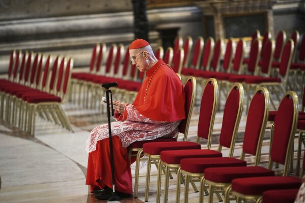 Cardinal Tarcisio Bertone sits in St. Peter's Basilica ahead of the arrival of the body of Pope Francis, who will lie in state for three days, at the Vatican, Wednesday, April 23, 2025. (AP Photo/Alessandra Tarantino)