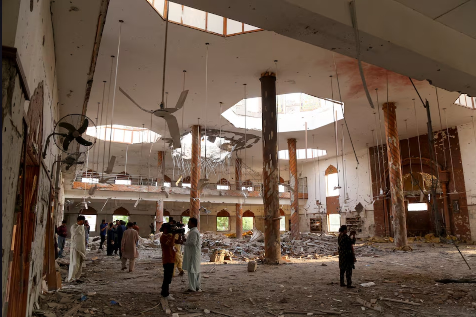 Members of the media film the inside of a building after it was hit by an Indian strike in Bahawalpur, Pakistan, May 7, 2025. Photo: Reuters