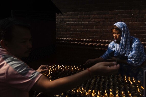 Nepalese devotees light butter lamps during Buddha Jayanti, also known as Buddha Purnima festival, to celebrate Buddha's birthday, in Boudhanath Stupa, Kathmandu, Nepal, Monday, May 12, 2025. (AP Photo/Niranjan Shrestha)