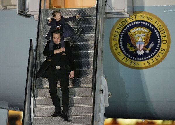 Elon Musk carries his son X Æ A-Xii as they arrives on Air Force One with President Donald Trump, not pictured, at Miami International Airport, April 12, 2025, in Miami, Fla. (AP Photo/Manuel Balce Ceneta, File)