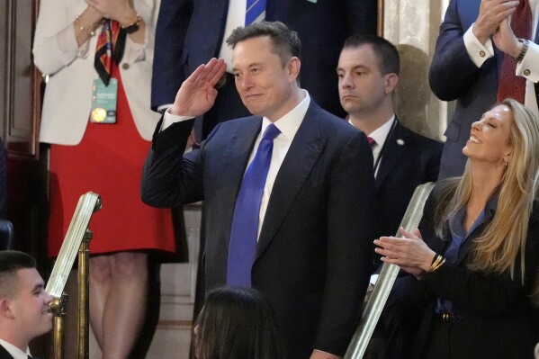 Elon Musk gestures as President Donald Trump addresses a joint session of Congress at the Capitol in Washington, March 4, 2025. (AP Photo/Alex Brandon, File)