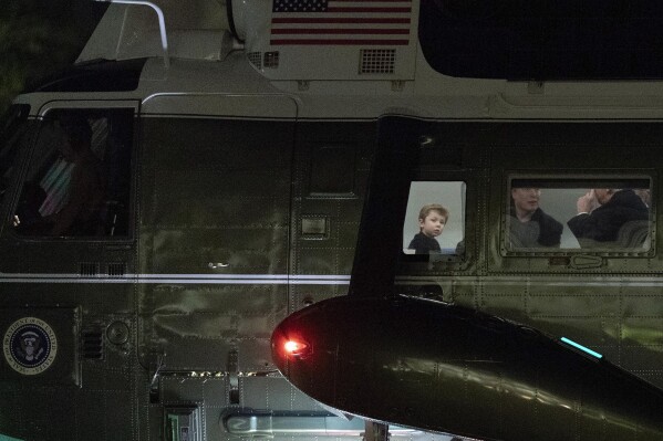 President Donald Trump speaks with Elon Musk as his son X Æ A-Xii looks on as they arrive on Marine One at the South Lawn of the White House in Washington, April 13, 2025. (AP Photo/Jose Luis Magana, File)