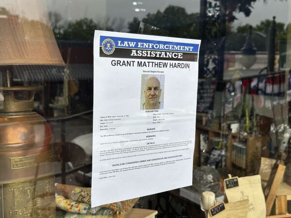 A flier looking for Grant Hardin hangs on the glass of a business, Thursday, May 29, 2025, in downtown Calico Rockt, Ark. (AP Photo/Nicholas Ingram)