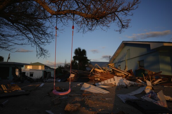 A child's swing still hangs on a tree, surrounded by debris from homes destroyed by Hurricane Milton, on Manasota Key, Fla., Oct. 12, 2024. (AP Photo/Rebecca Blackwell, File)